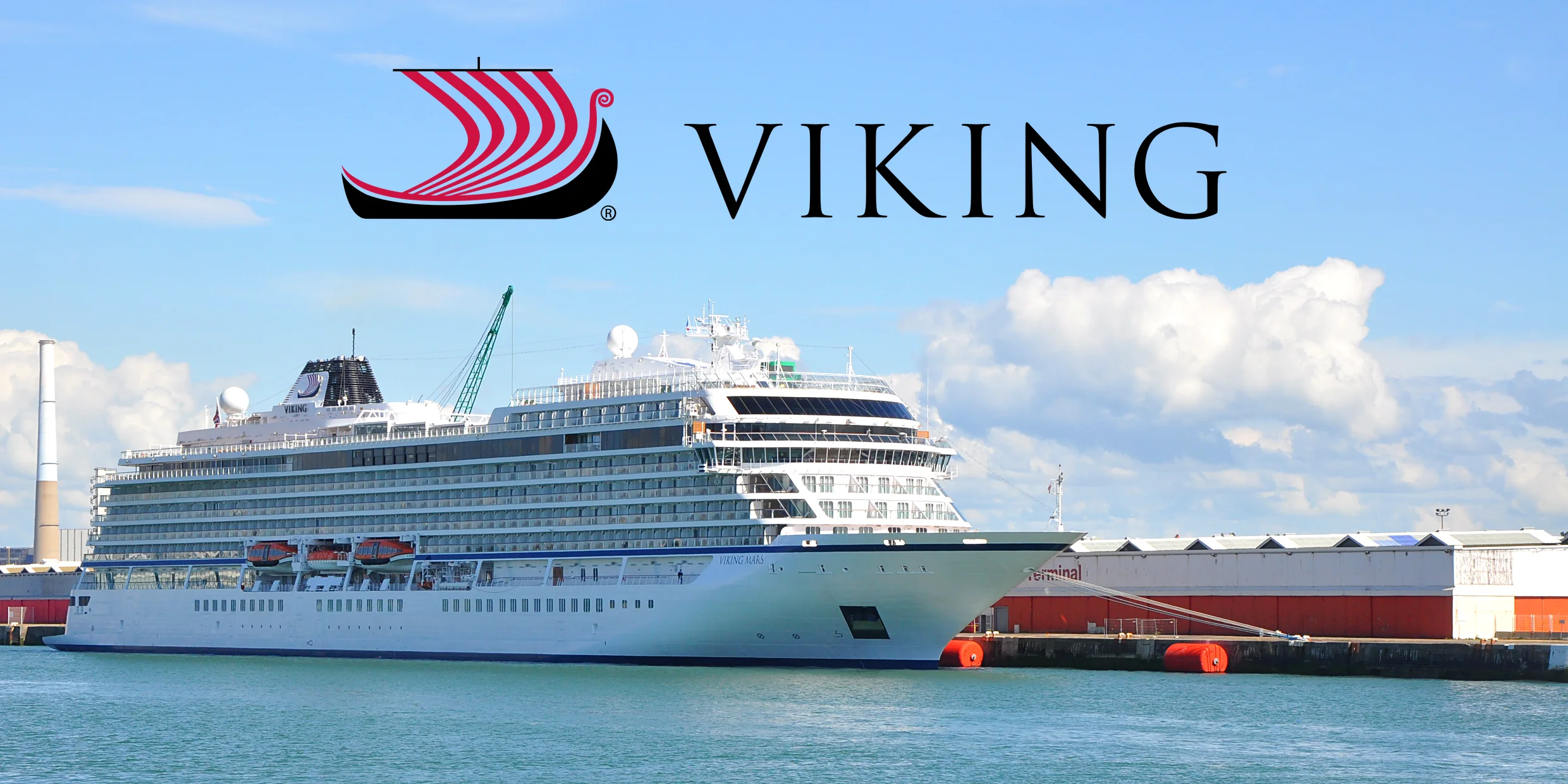 Viking Mars, a Viking ocean ship, in port on bright turquoise water under the Viking logo
