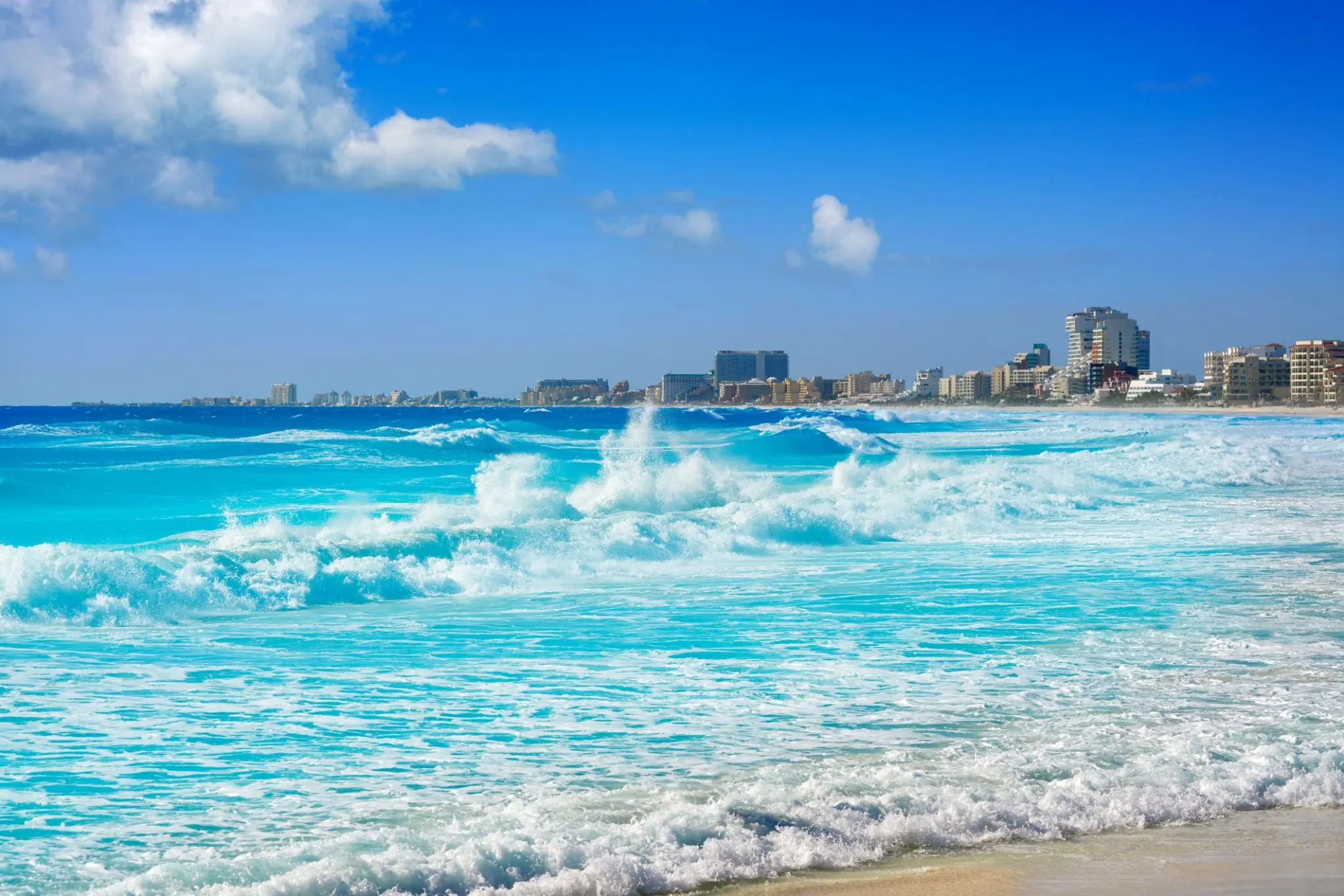 Turquoise surf and white-capped waves along Cancun’s Hotel Zone beach