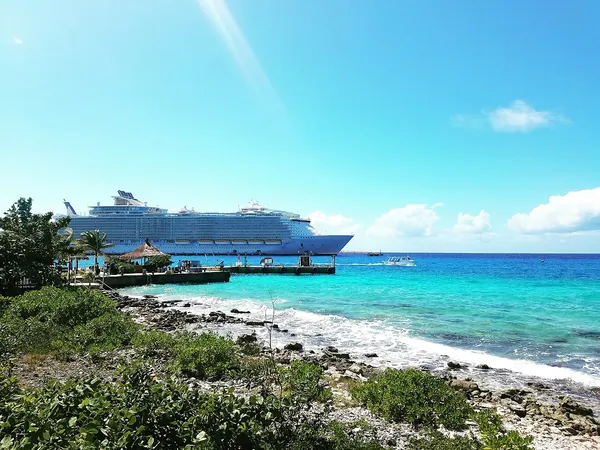 Oasis of the Seas docked beside turquoise water in Cozumel, Mexico