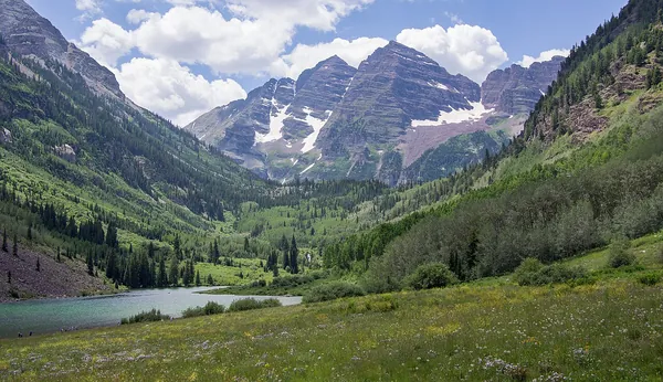 Maroon Lake and the Maroon Bells under puffy summer clouds