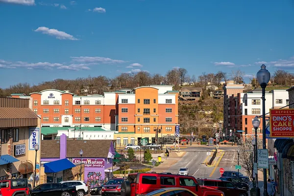 Colorful buildings and shops in downtown Branson, Missouri under a blue sky