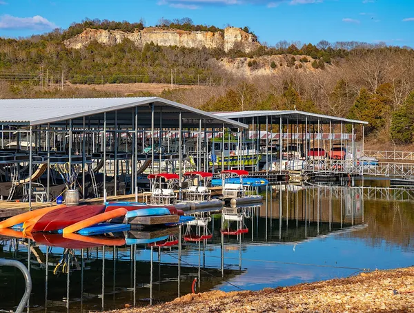 Colorful boats docked at the Table Rock State Park marina below an Ozark bluff