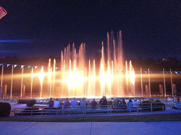 A colorful fountain show lit up at night in Branson