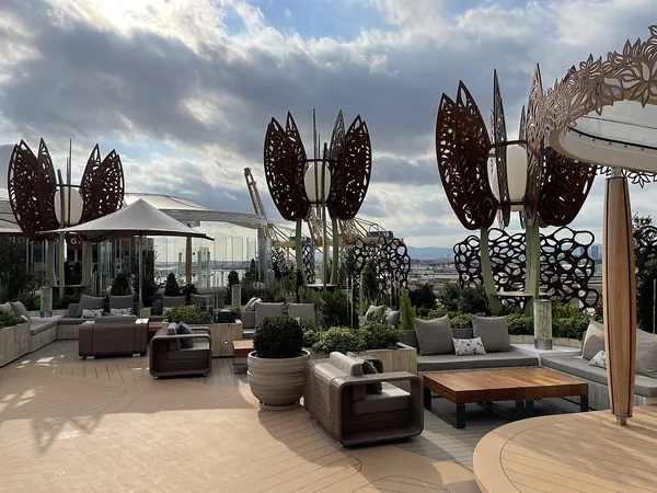 Lounge seating and sculptural art in the Rooftop Garden on the top deck of Celebrity Apex