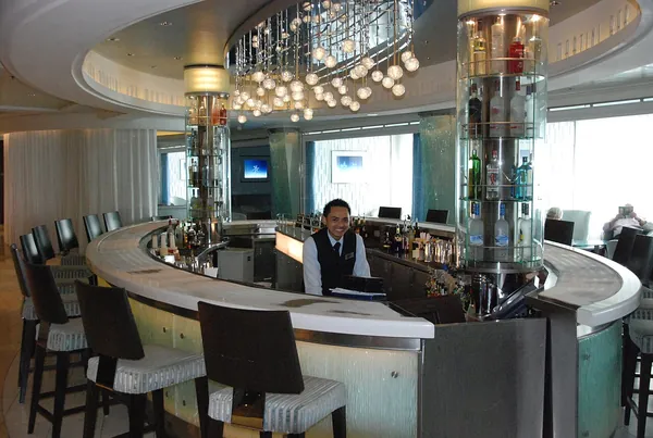 The glowing curved counter of the Martini Bar on Celebrity Equinox