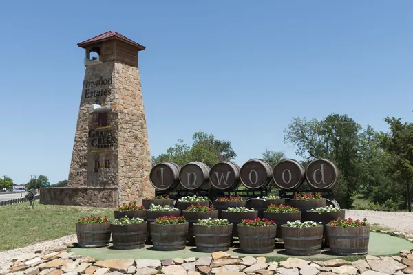 Wine casks stacked beside a stone tower at Mendelbaum Cellars Winery, Gillespie County, Texas