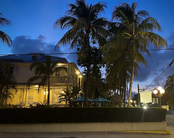 Palm trees and a historic guest house at twilight in Key West