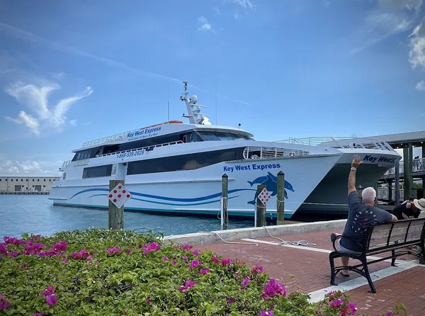 A ferry docked at the Key West Bight Ferry Terminal under a blue sky