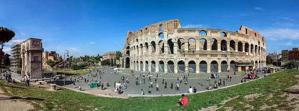 The Colosseum in Rome under a blue sky