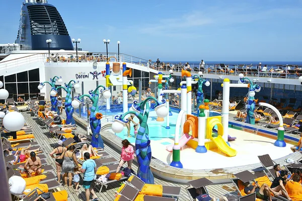Families at the colorful kids’ splash and play area on the pool deck of MSC Opera