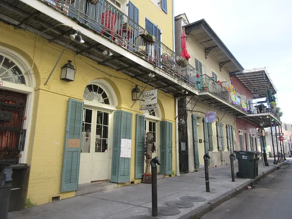 Yellow buildings with green shutters and iron balconies in the French Quarter