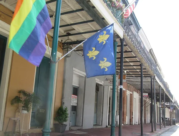Flags hanging from an iron-lace balcony in the French Quarter
