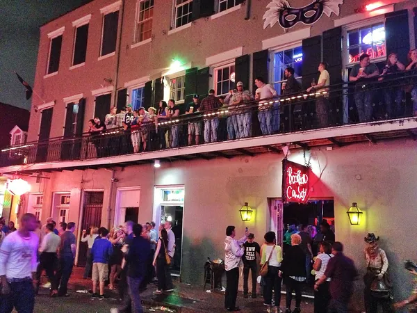 Lively Bourbon Street balconies lit up at night
