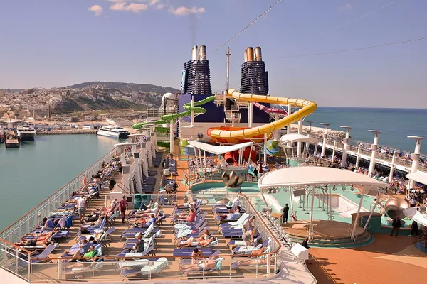 The Aqua Park water slides above a busy pool deck on Norwegian Epic