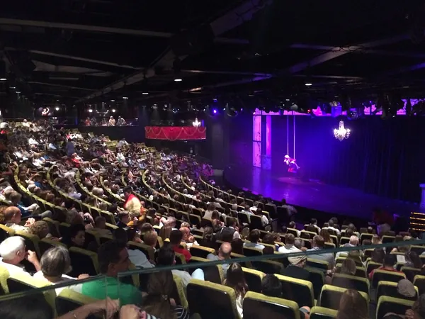 An audience watching a show in the theater aboard Norwegian Epic
