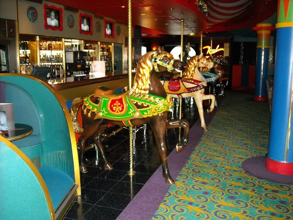 Carousel horses and colorful decor at the Carousel Bar on Norwegian Star