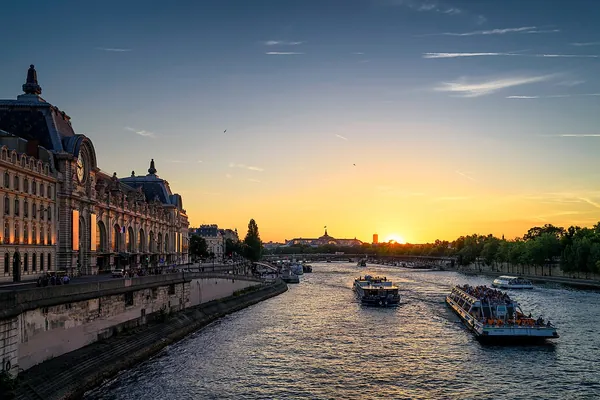 Musée d’Orsay exterior glowing at sunset along the Seine