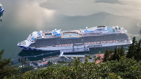 Discovery Princess docked in Juneau, Alaska, surrounded by green mountains