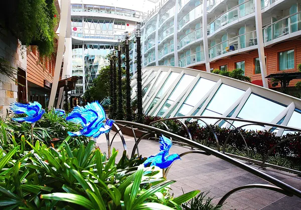 Lush plantings and walkways in Central Park, open to the sky between the cabin decks of Allure of the Seas