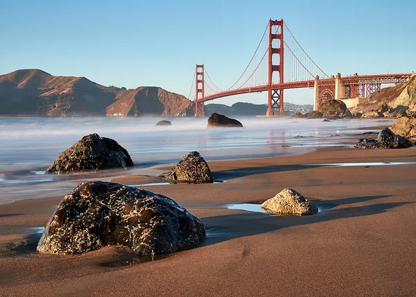 The Golden Gate Bridge and rocky Marshall’s Beach in San Francisco