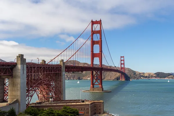 The Golden Gate Bridge’s red tower under a blue sky, San Francisco