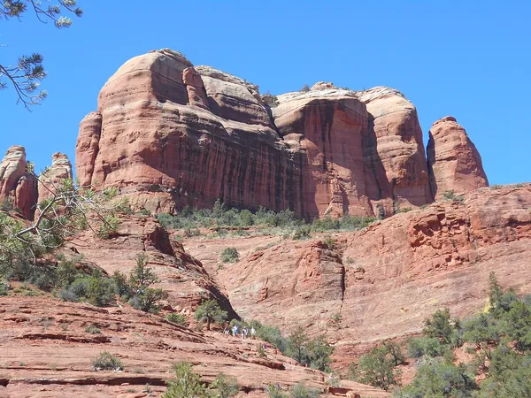 Red sandstone formations of Cathedral Rock against a blue sky