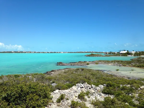 Shallow turquoise water and a sandy point in Turks and Caicos