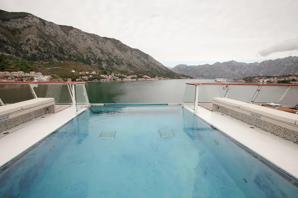 The infinity pool at the stern of Viking Star, with the mountains around Kotor, Montenegro beyond