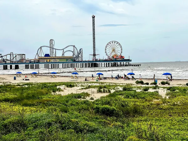 Galveston Island Historic Pleasure Pier and its rides beyond the beach dunes
