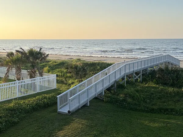 A white walkway over the dunes from the Seawall to the beach and the Gulf