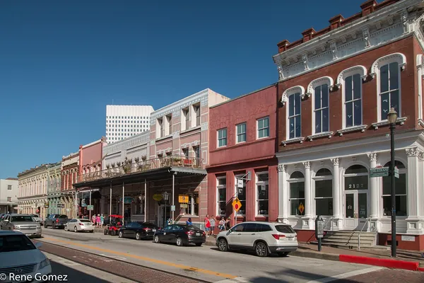 Colorful 19th-century storefronts with iron balconies in The Strand Historic District