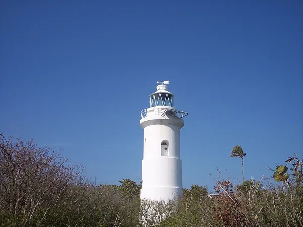 White lighthouse under a blue sky on Great Stirrup Cay