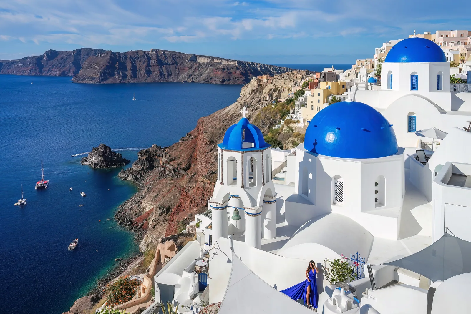 Blue-domed white churches of Oia above the bright blue Aegean Sea, Santorini, Greece