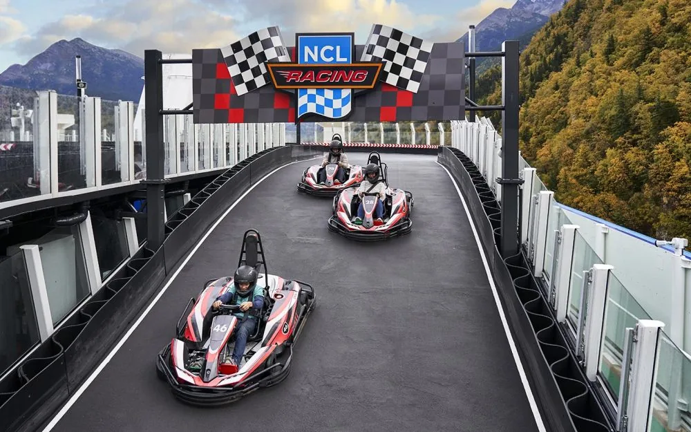 Go-karts on the Norwegian Bliss race track sailing past Alaska mountains