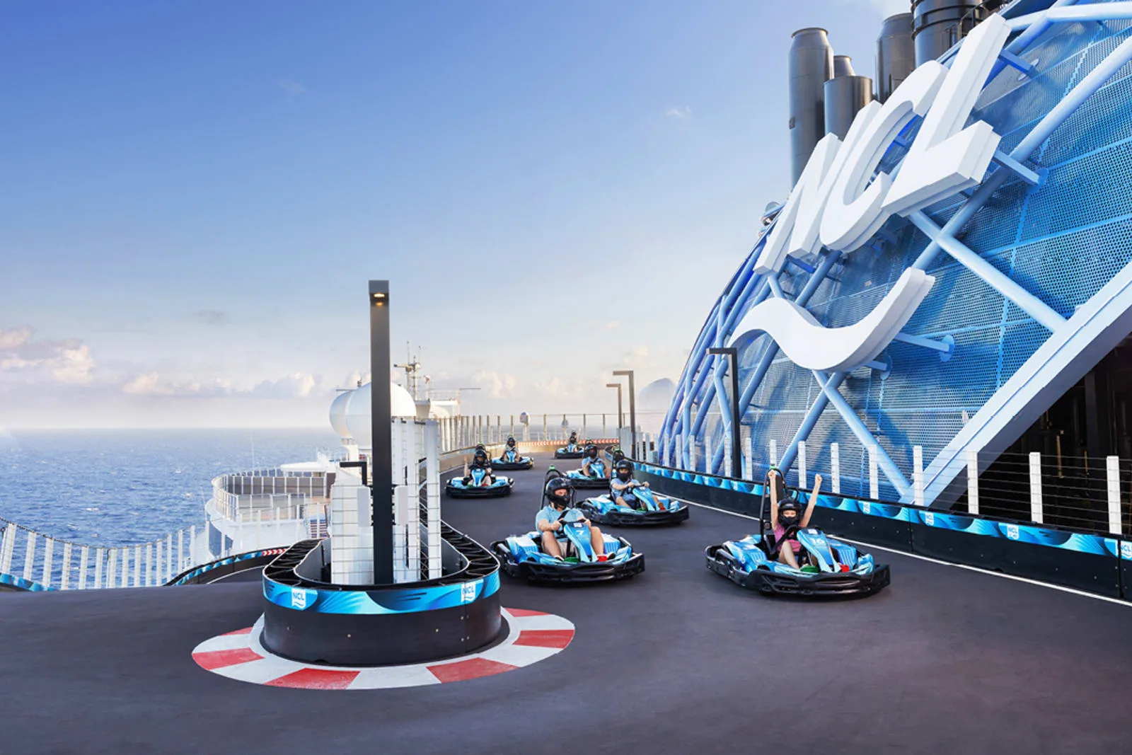 Go-karts racing on the Norwegian Prima Speedway beside the giant NCL logo