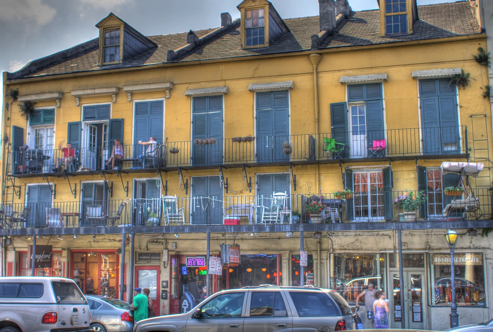 Colorful French Quarter buildings with iron-lace balconies along Decatur Street in New Orleans