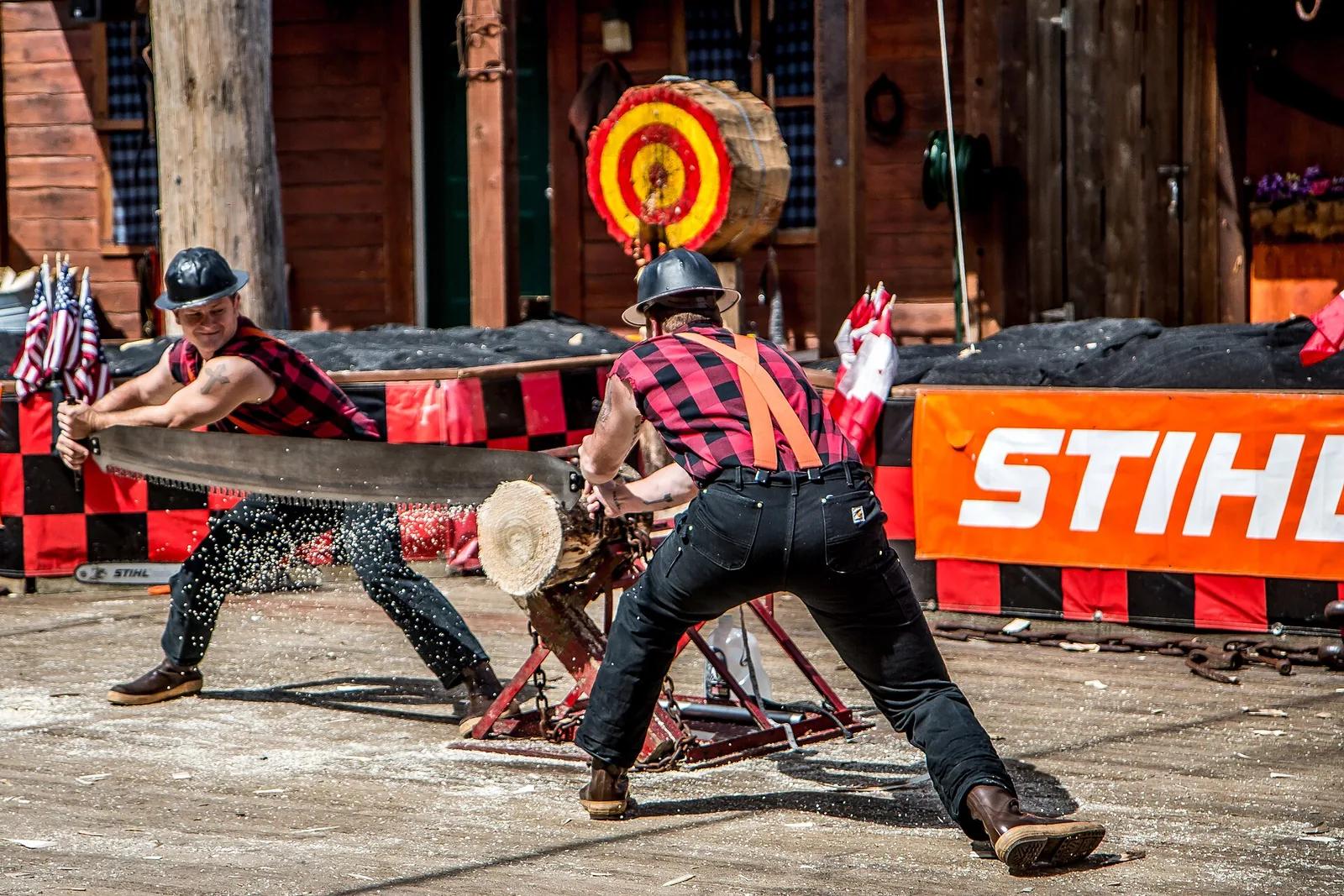 Two lumberjacks racing with an axe and saw at the Great Alaskan Lumberjack Show in Ketchikan