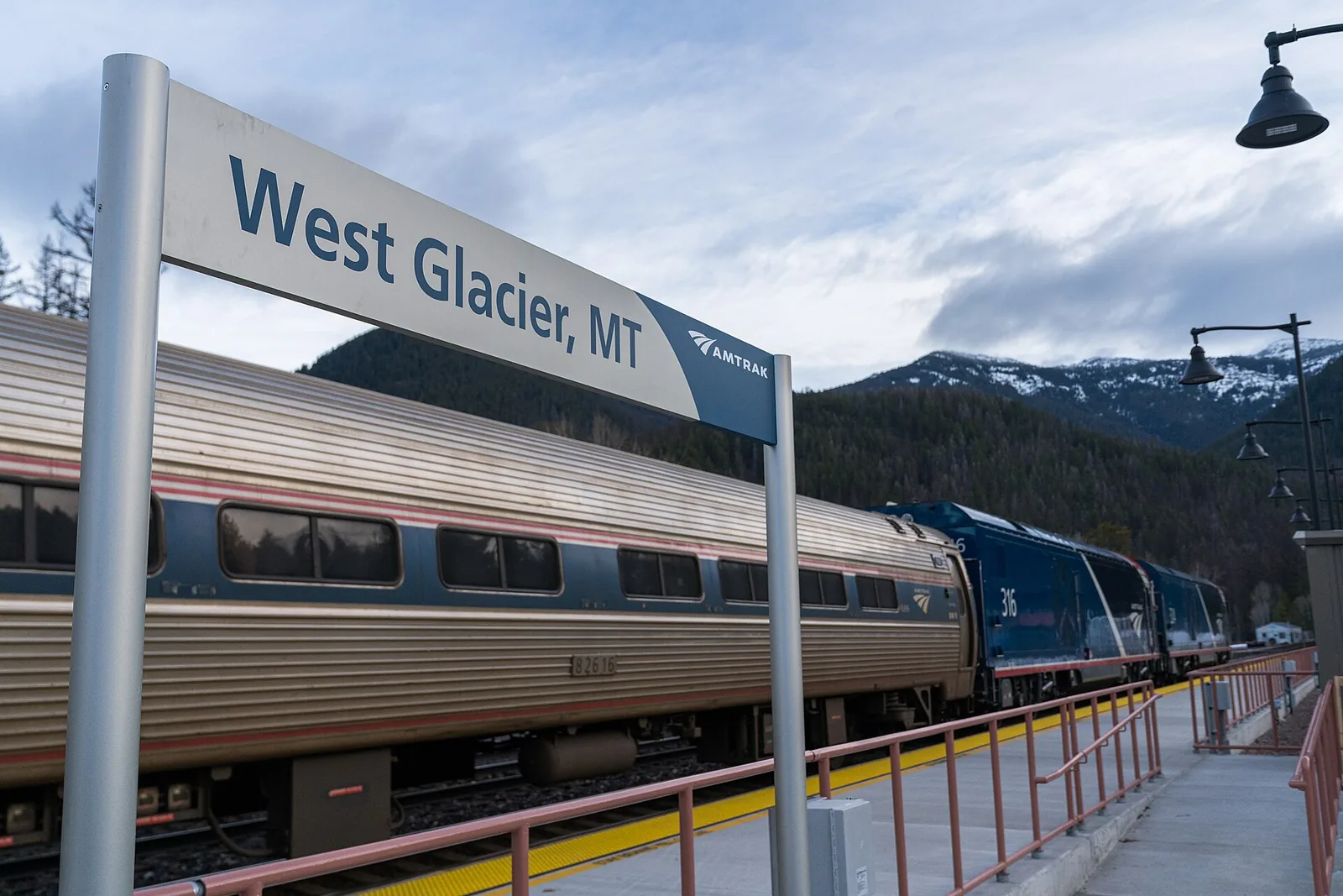 Amtrak Empire Builder at the West Glacier station with mountains and blue sky
