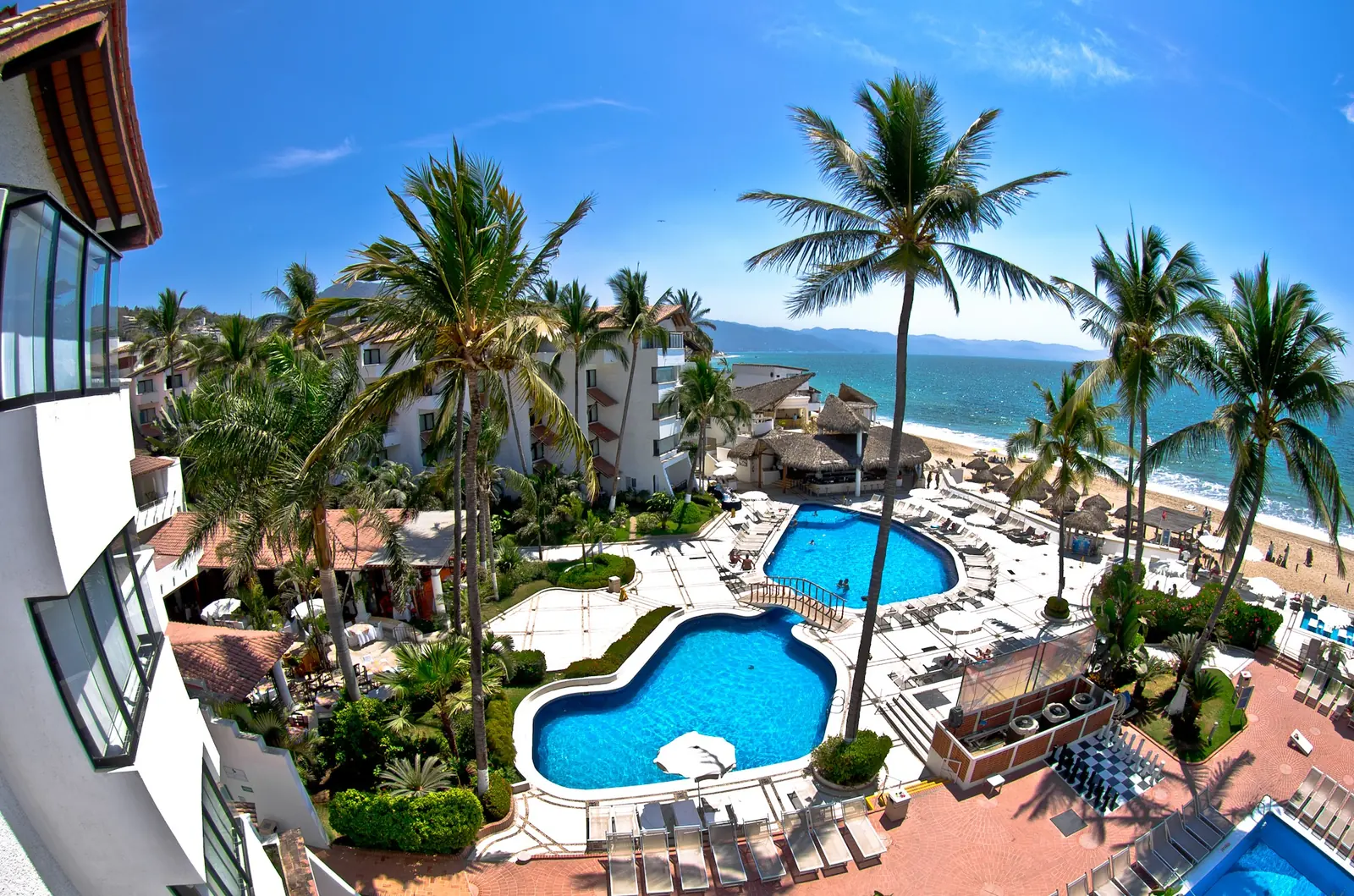 Palm-lined resort pools beside the ocean on Mexico’s Pacific coast