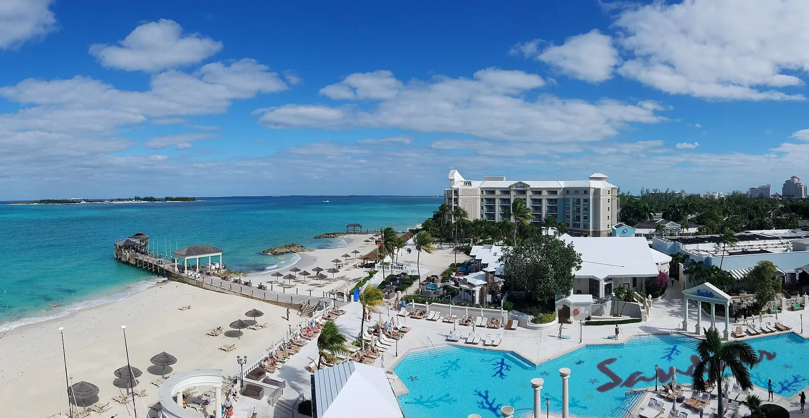 Pool, beach and turquoise water at Sandals Bahamas Nassau