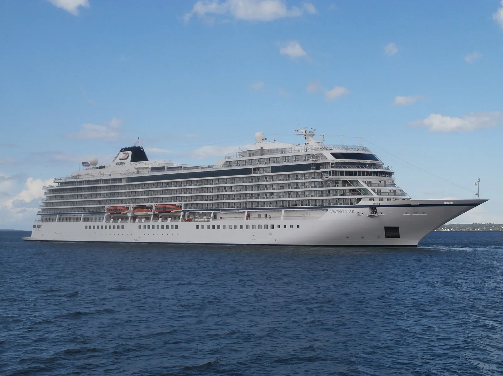Viking Star ocean ship sailing out of Tallinn on blue water