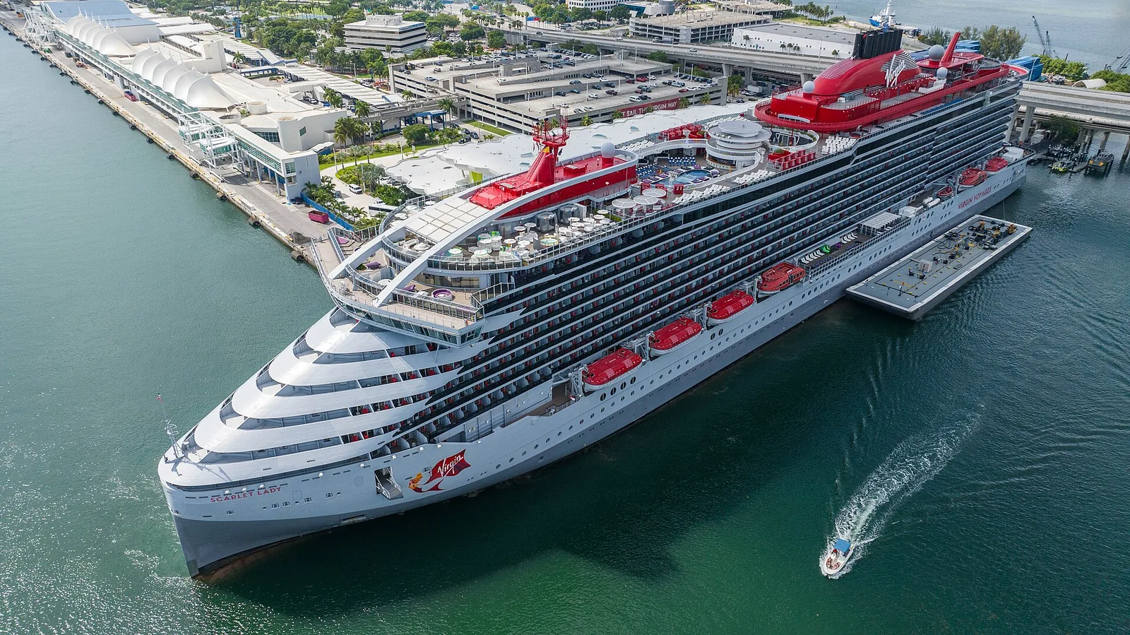Virgin Voyages’ Scarlet Lady docked at PortMiami beside the turquoise water of Biscayne Bay
